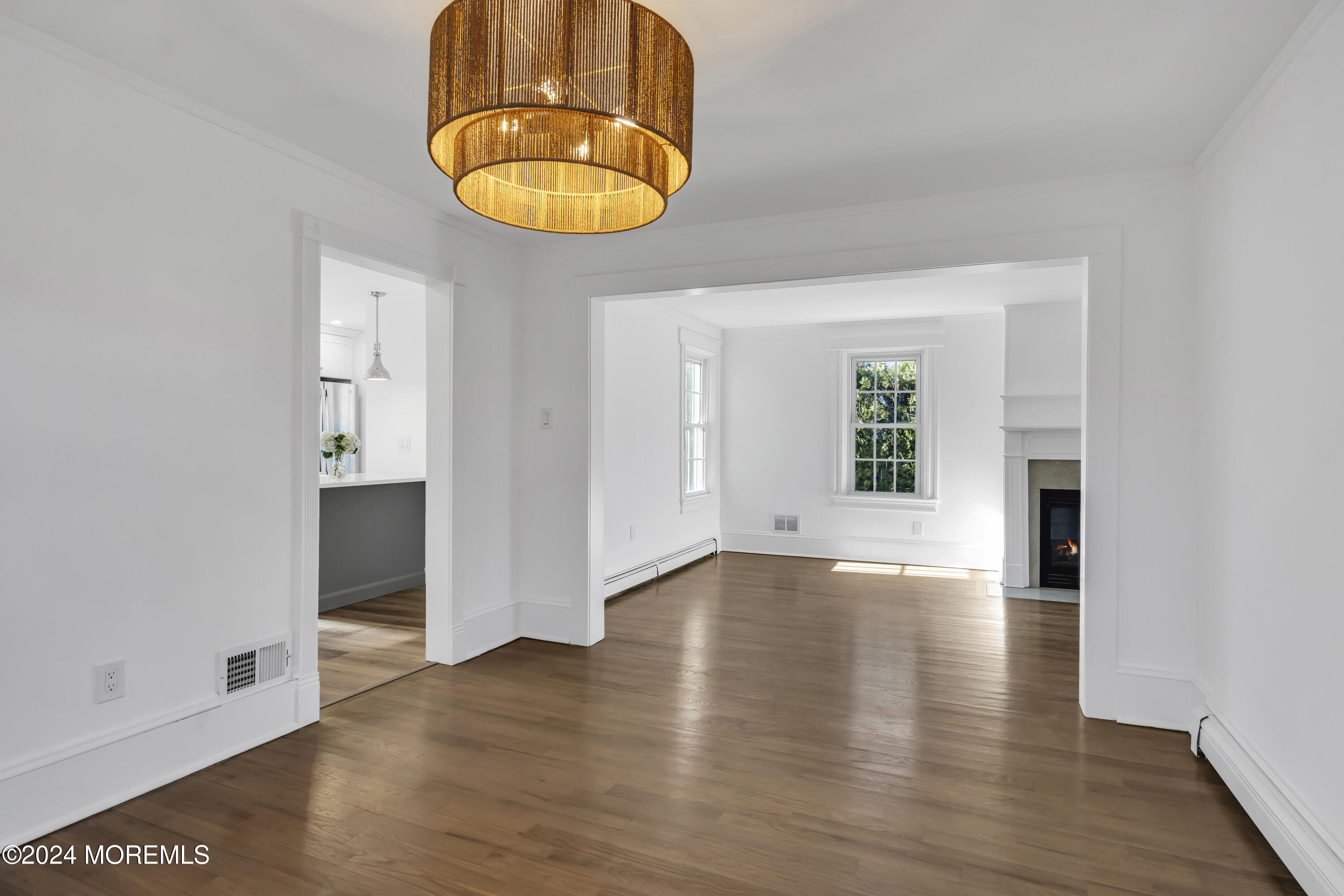 709 Prospect Avenue Spring Lake Heights, NJ 07762 - Photo 12 of 32 an empty room with wooden floor and windows
