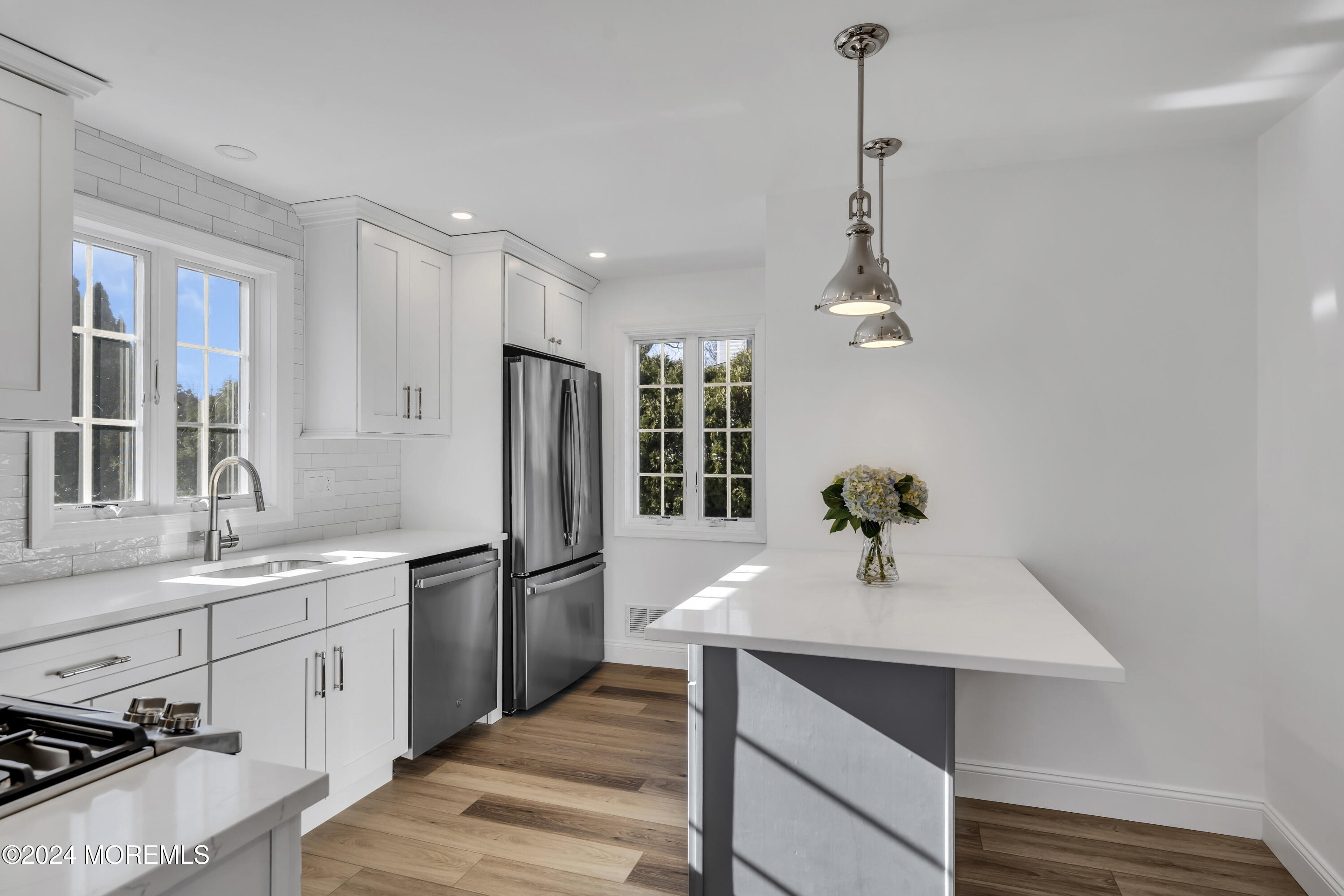 709 Prospect Avenue Spring Lake Heights, NJ 07762 - Photo 14 of 32 a kitchen with a sink stainless steel appliances and white cabinets