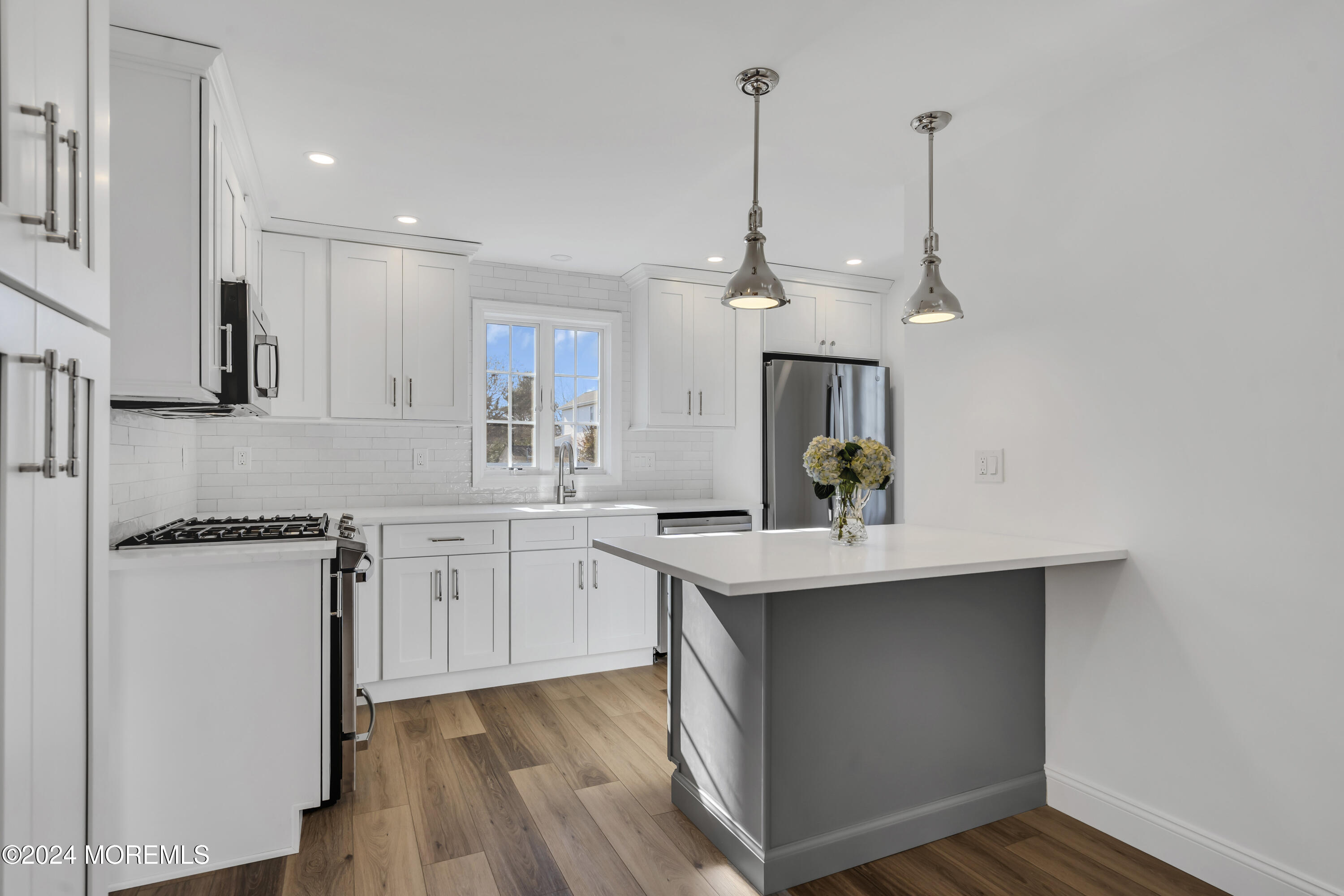 709 Prospect Avenue Spring Lake Heights, NJ 07762 - Photo 15 of 32 a kitchen with stainless steel appliances granite countertop a sink stove and refrigerator
