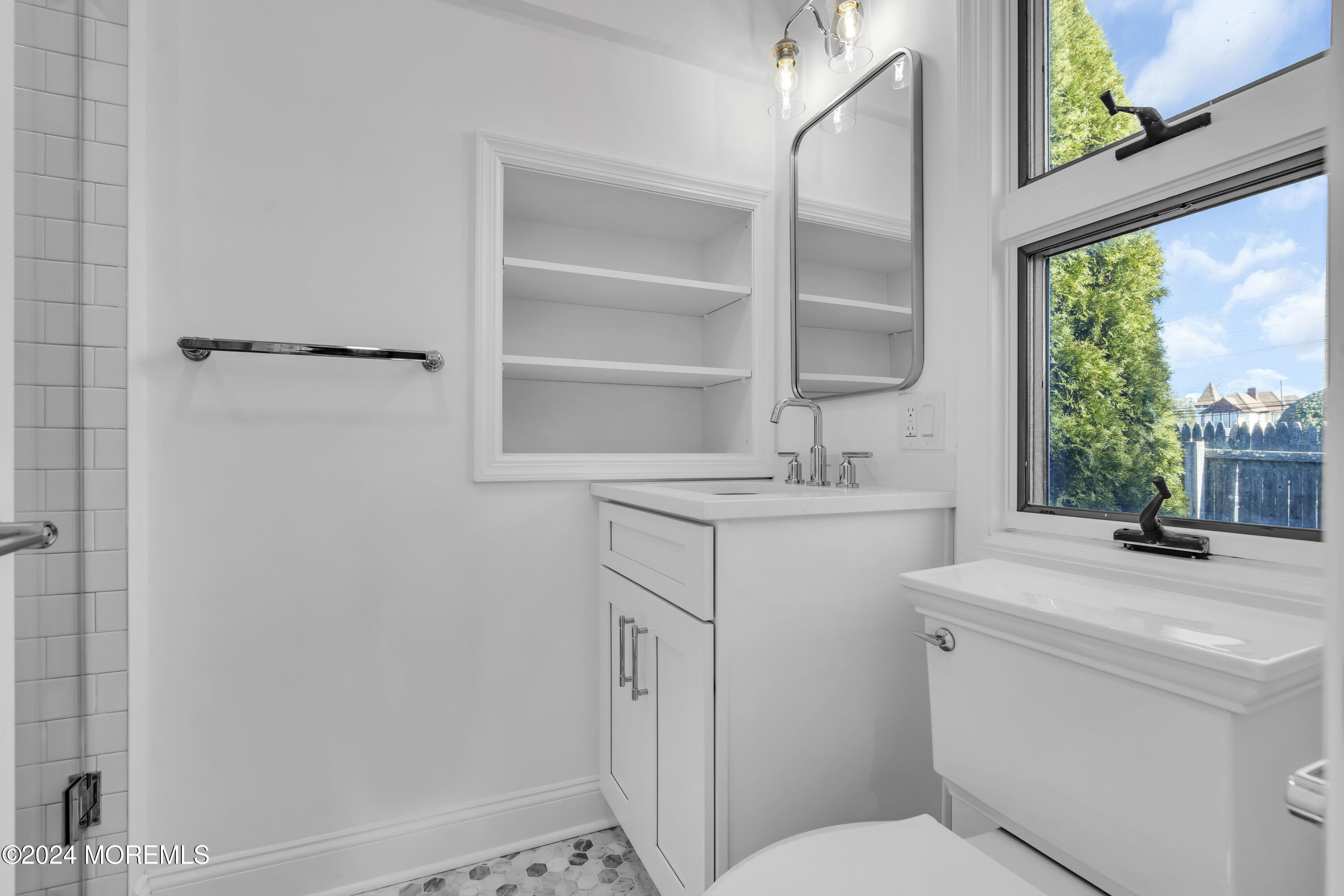 709 Prospect Avenue Spring Lake Heights, NJ 07762 - Photo 20 of 32 a bathroom with a sink toilet and a window