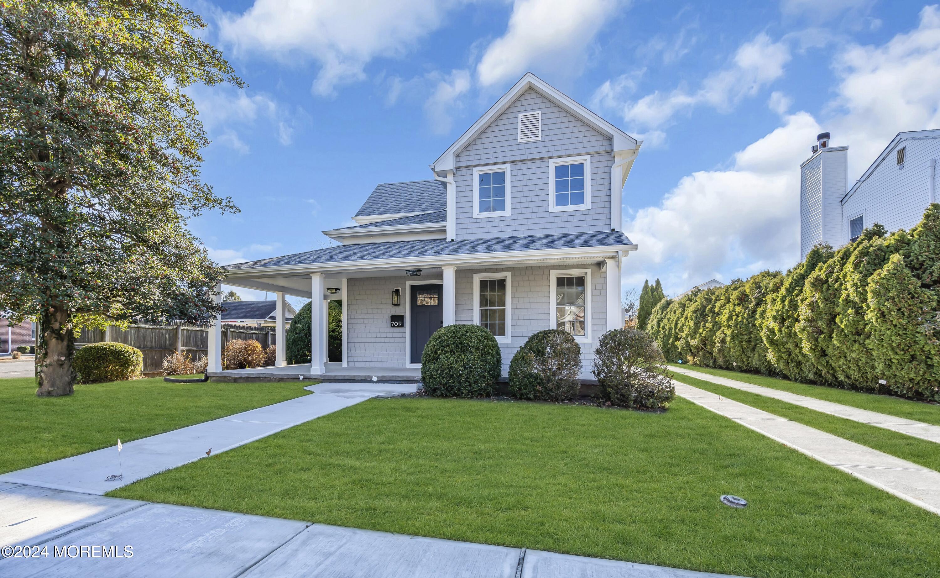 709 Prospect Avenue Spring Lake Heights, NJ 07762 - Photo 2 of 32 a front view of a house with a garden