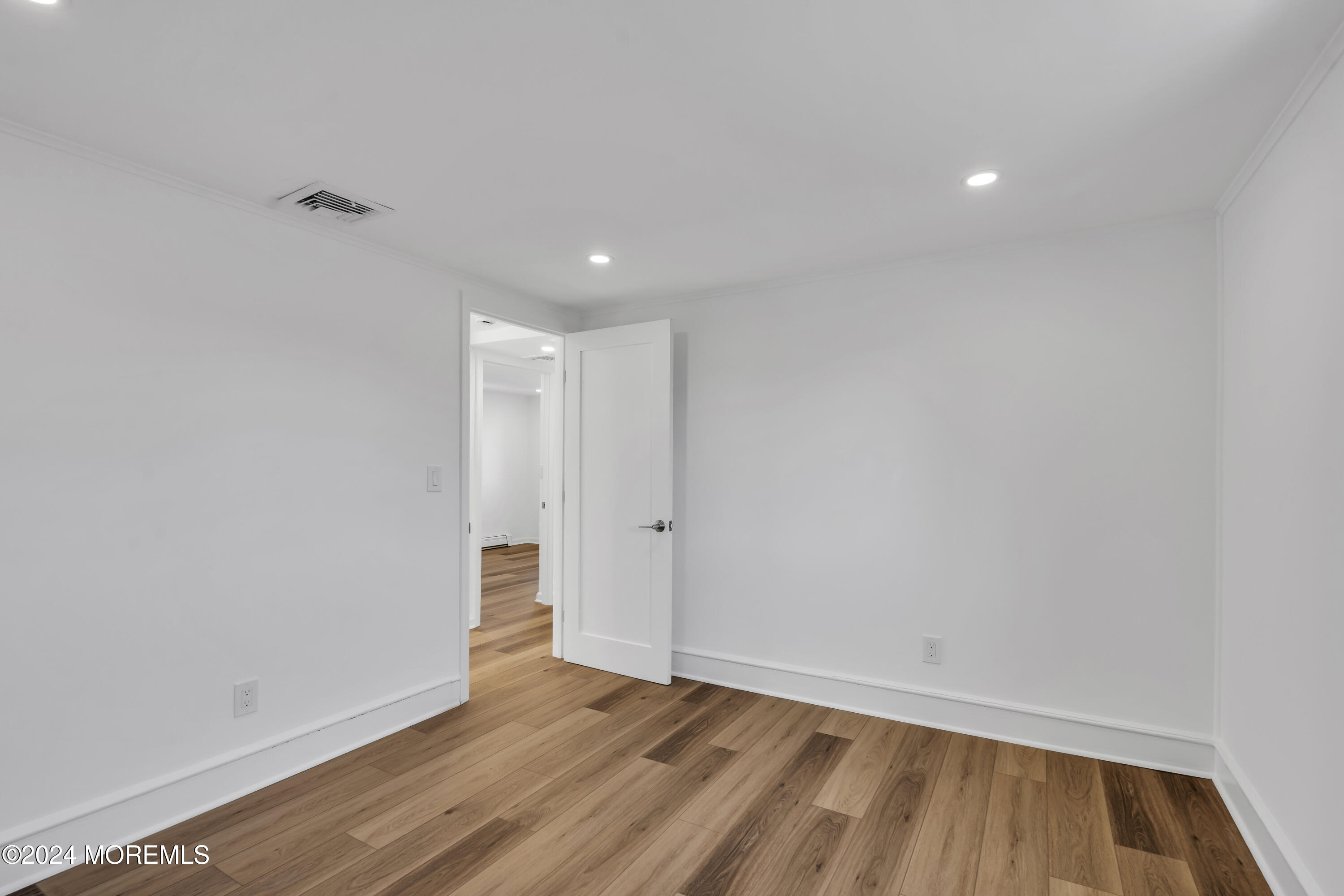 709 Prospect Avenue Spring Lake Heights, NJ 07762 - Photo 22 of 32 a view of an empty room with wooden floor and closet