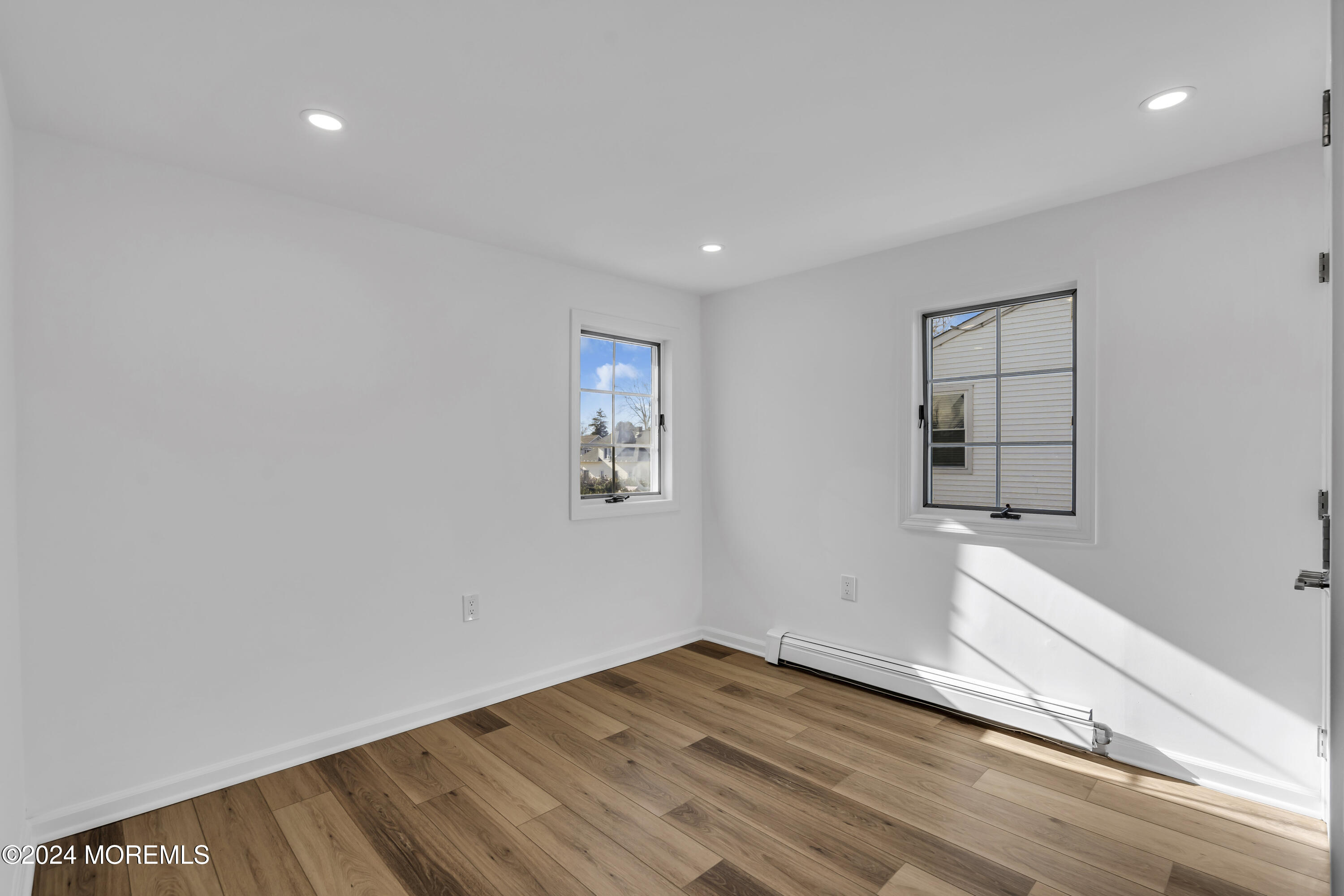 709 Prospect Avenue Spring Lake Heights, NJ 07762 - Photo 23 of 32 a view of empty room with wooden floor and fan