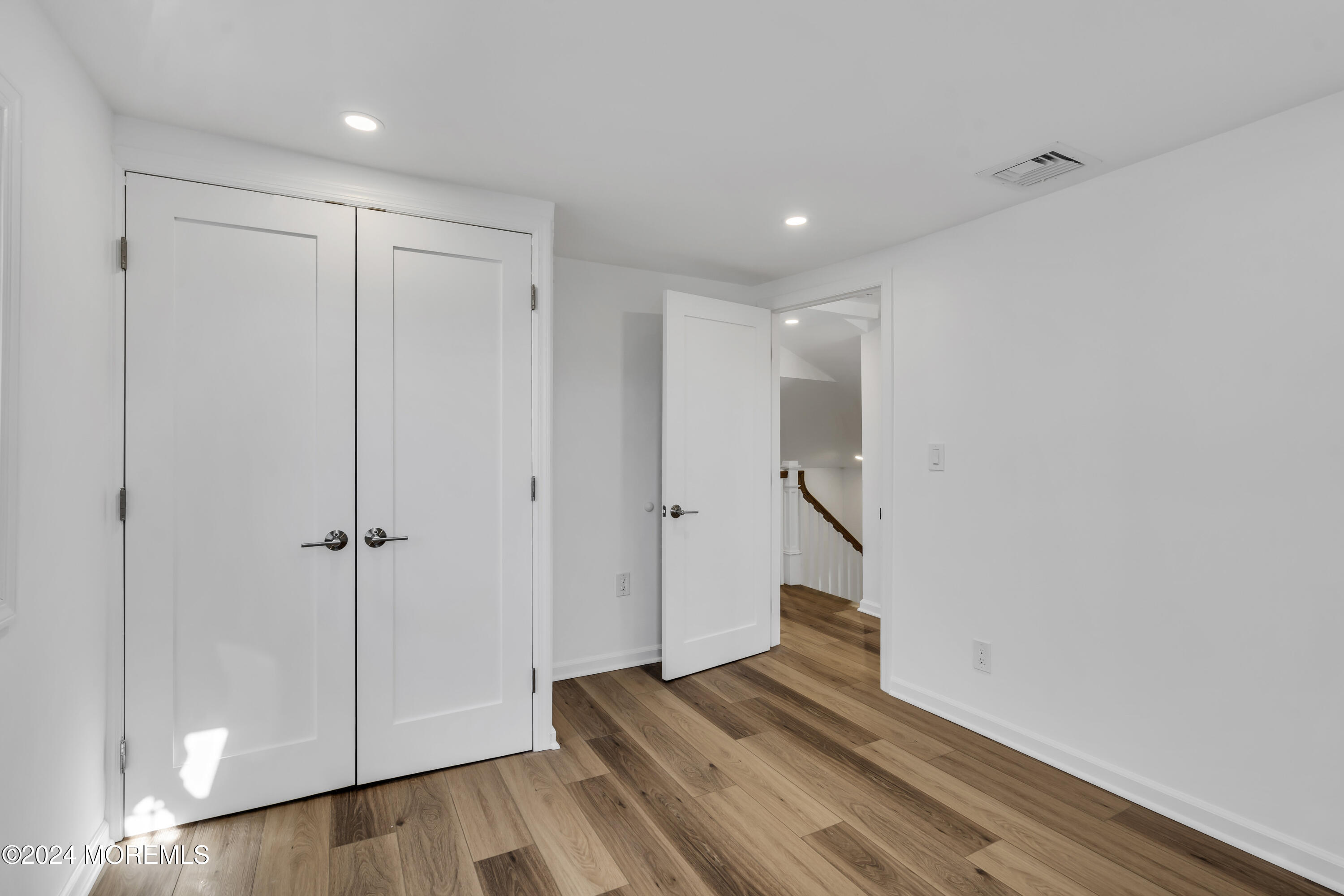709 Prospect Avenue Spring Lake Heights, NJ 07762 - Photo 24 of 32 a view of a hallway with wooden floor and staircase