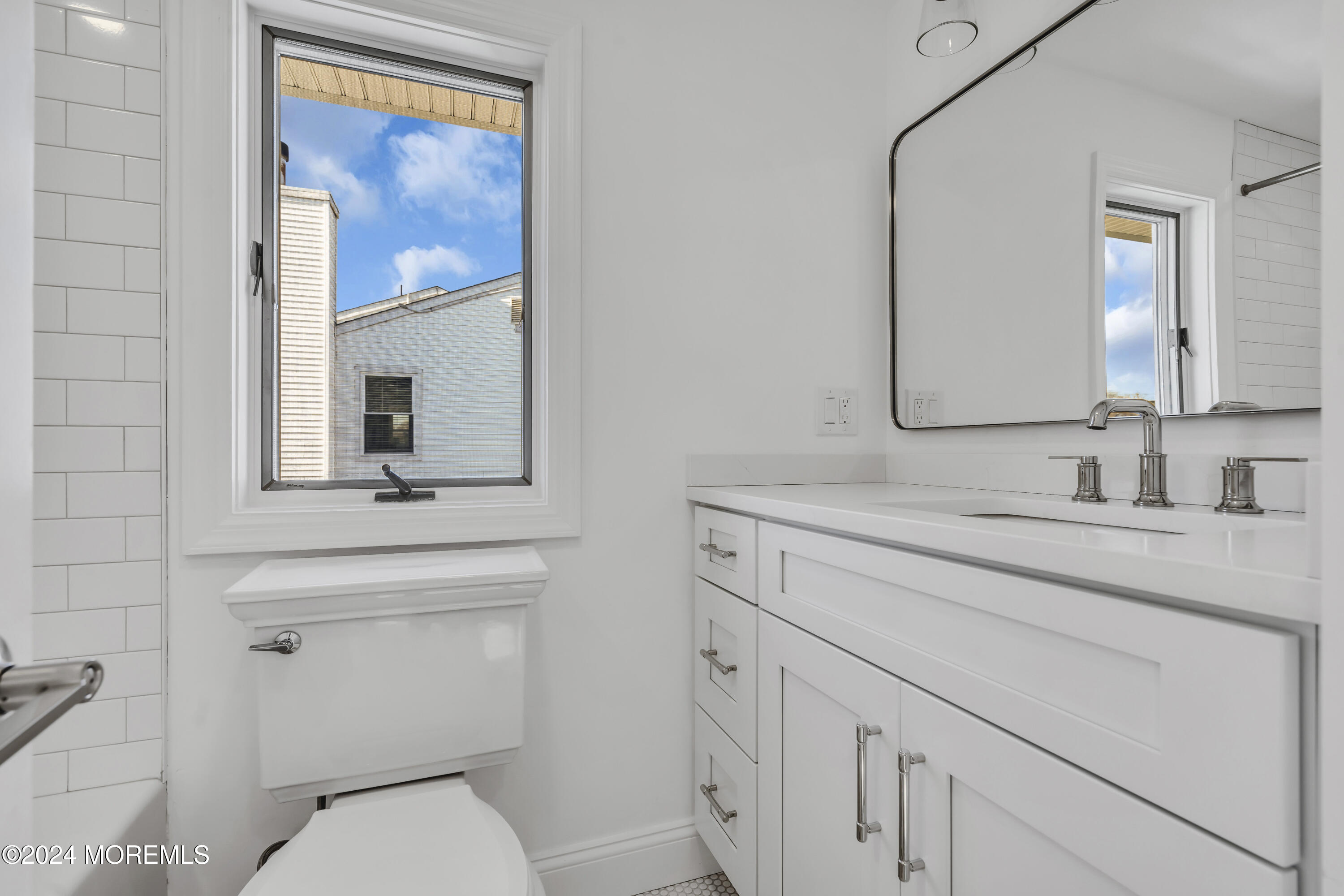 709 Prospect Avenue Spring Lake Heights, NJ 07762 - Photo 29 of 32 a bathroom with a toilet sink vanity and mirror