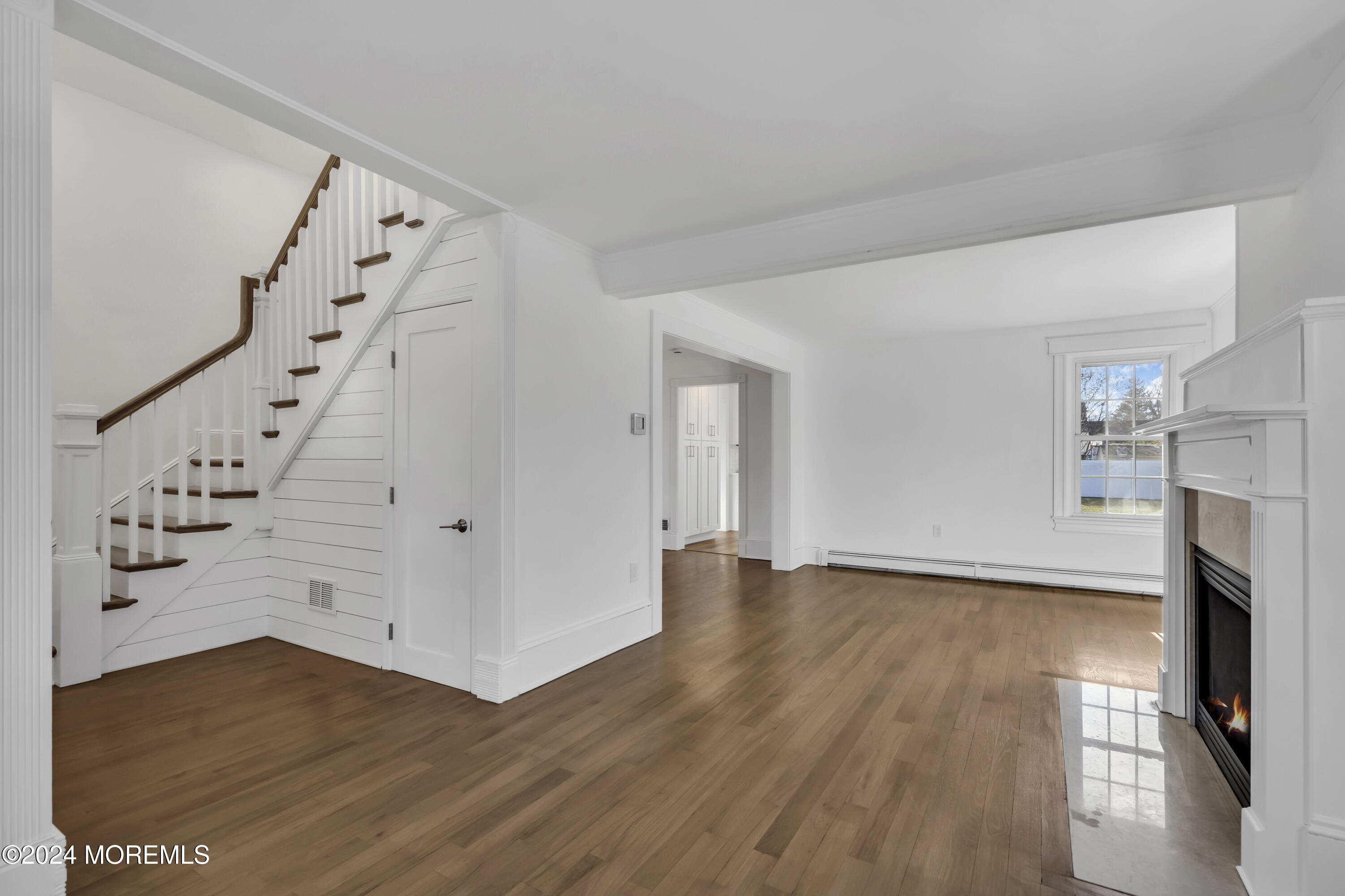 709 Prospect Avenue Spring Lake Heights, NJ 07762 - Photo 8 of 32 wooden floor in an empty room with a fireplace