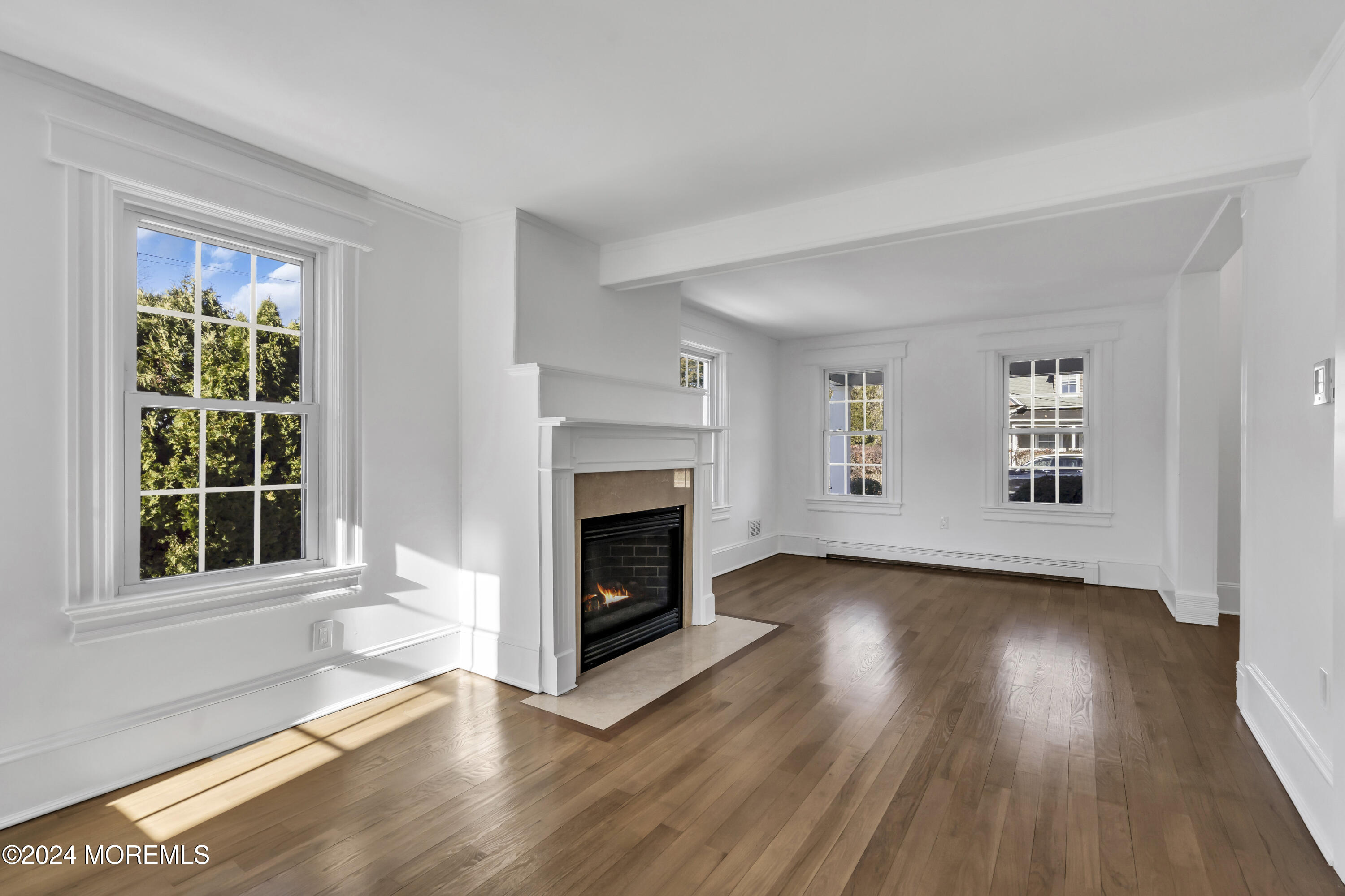 709 Prospect Avenue Spring Lake Heights, NJ 07762 - Photo 9 of 32 a view of an empty room with wooden floor and a window