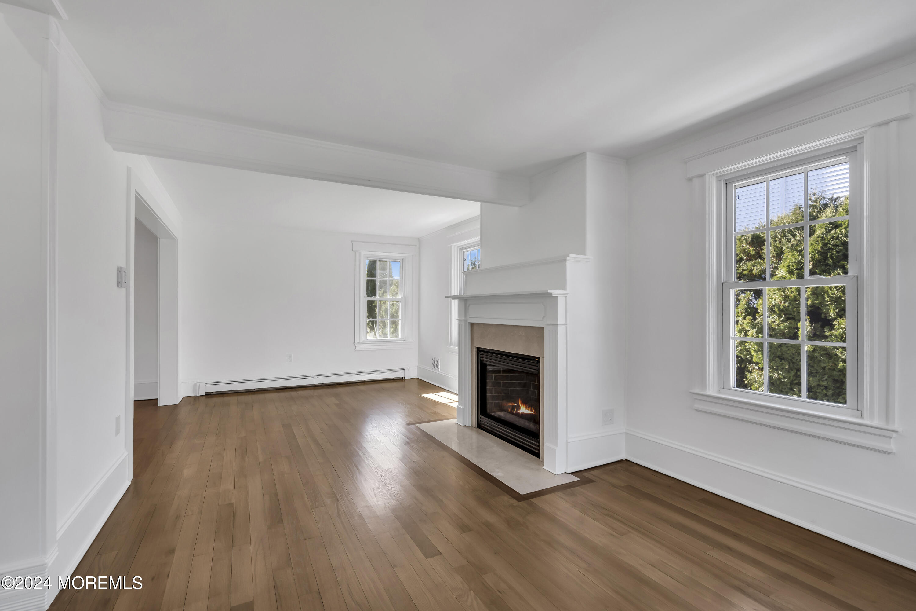 709 Prospect Avenue Spring Lake Heights, NJ 07762 - Photo 10 of 32 a view of an empty room with wooden floor fridge and a window