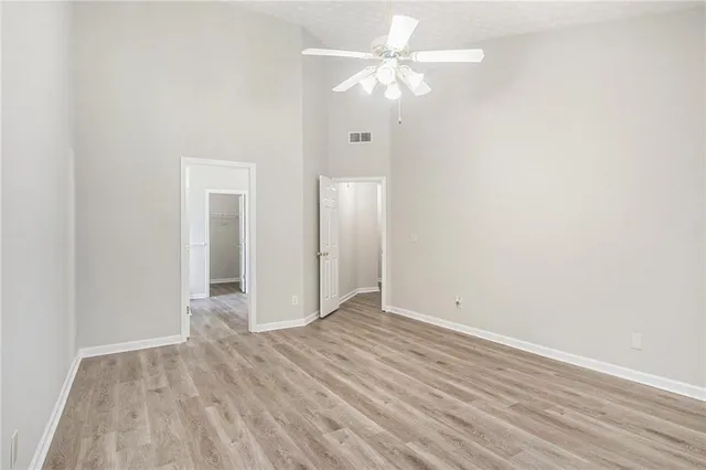 a view of an empty room with wooden floor