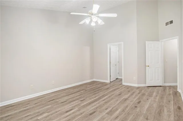 a view of an empty room with wooden floor