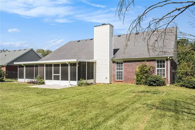 a front view of a house with a yard and trees