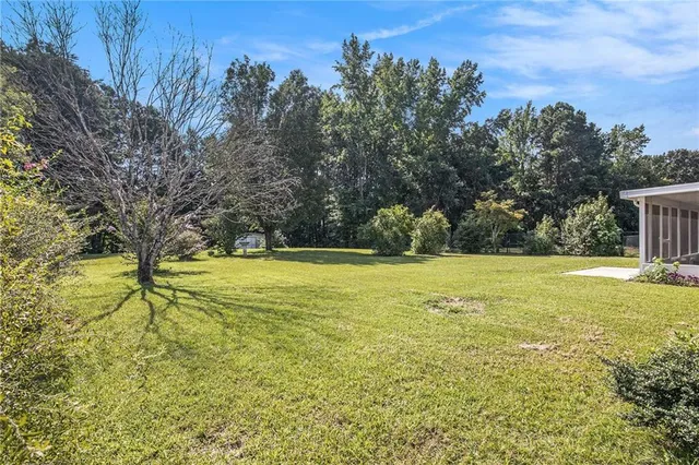 a view of yard with swimming pool and trees
