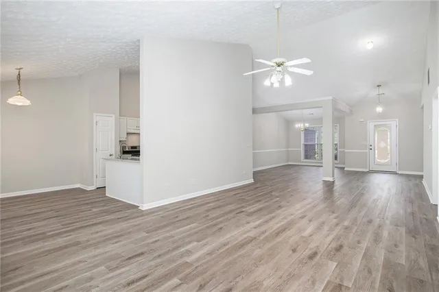 a view of an empty room and wooden floor
