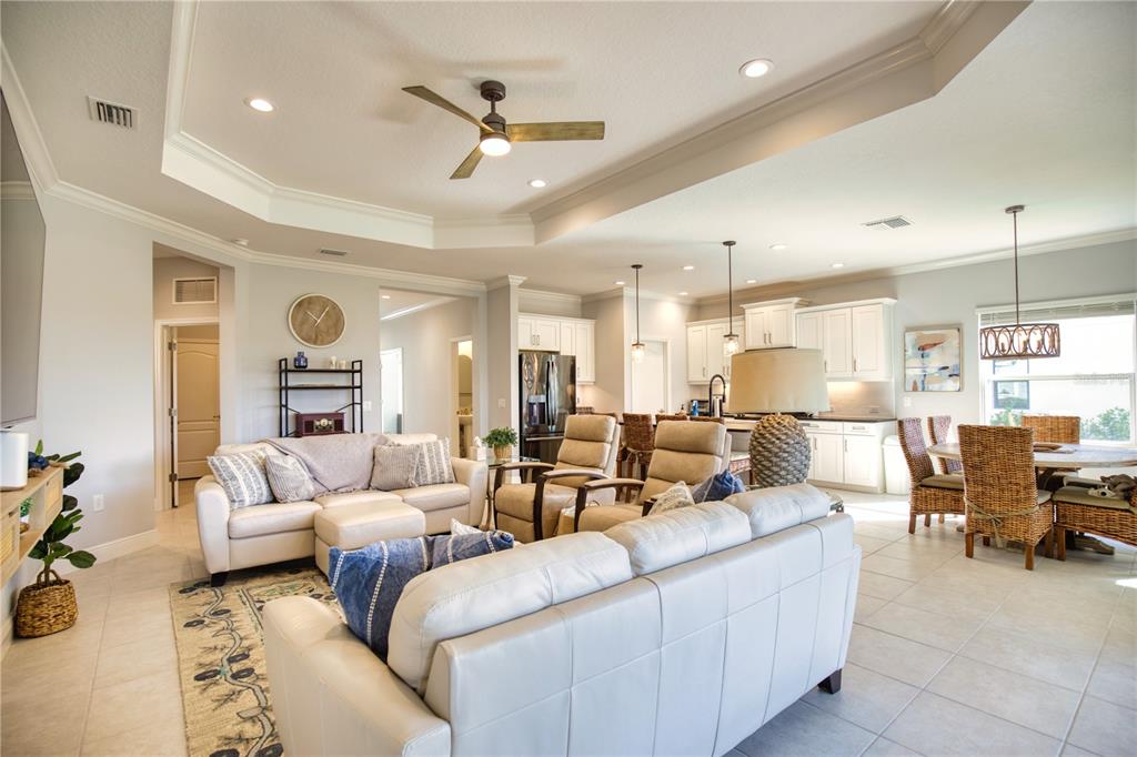 Undisclosed Address Venice, FL 34293 - Photo 14 of 45 a living room with furniture kitchen view and a chandelier