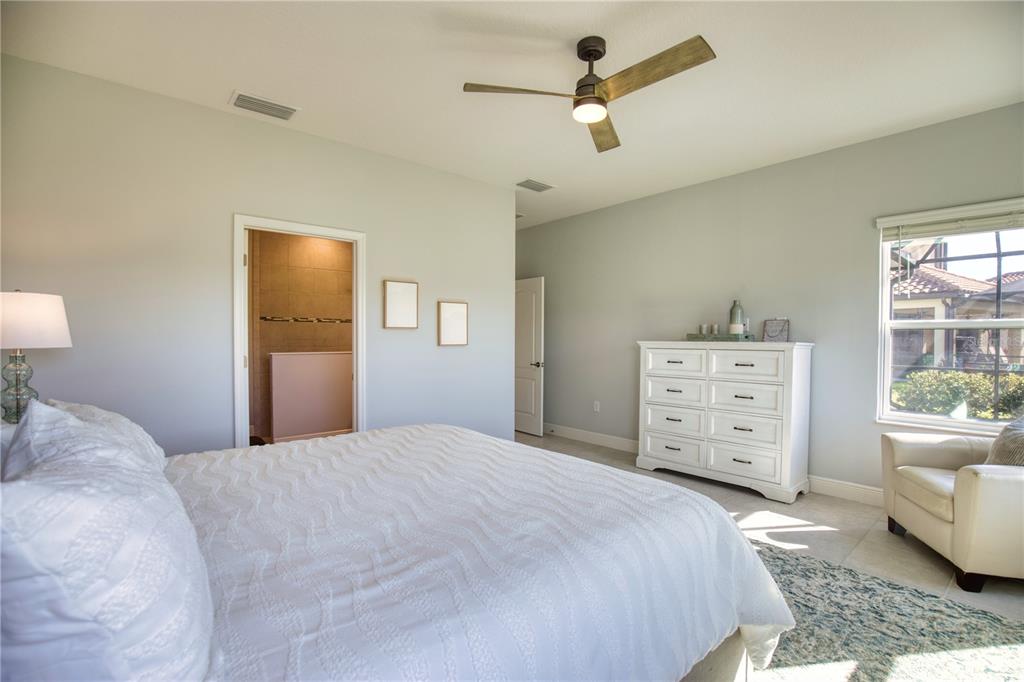 Undisclosed Address Venice, FL 34293 - Photo 19 of 45 a bedroom with a bed and a couch