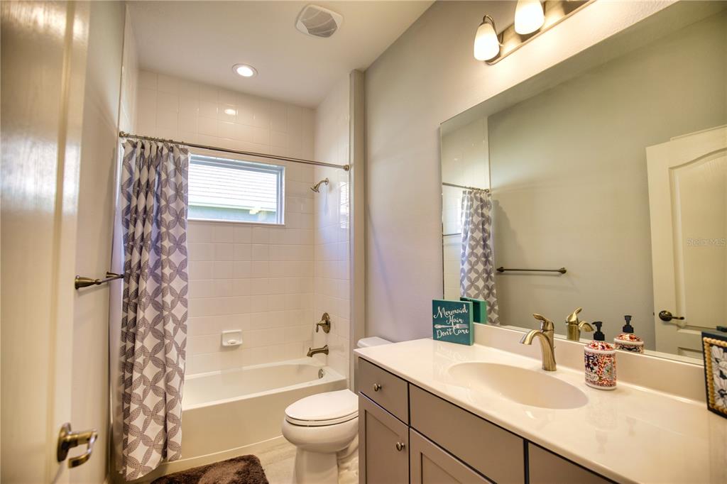 Undisclosed Address Venice, FL 34293 - Photo 25 of 45 a bathroom with a sink a toilet a mirror a bathtub and shower