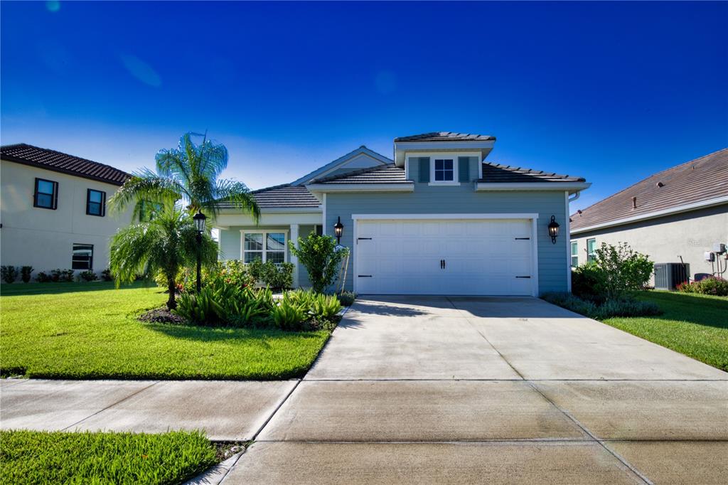 Undisclosed Address Venice, FL 34293 - Photo 35 of 45 a front view of a house with a yard and garage