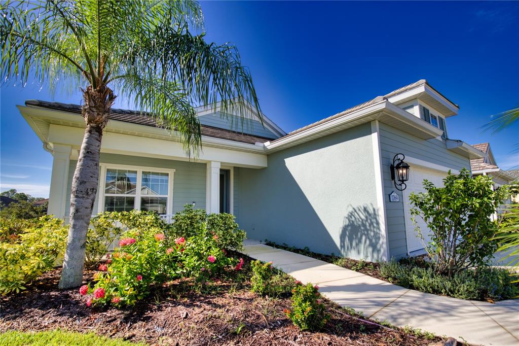 Undisclosed Address Venice, FL 34293 - Photo 4 of 45 a front view of a house with a yard