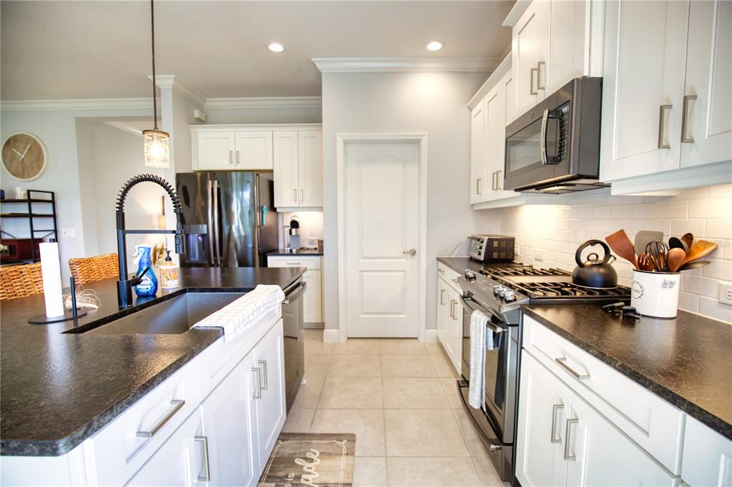Undisclosed Address Venice, FL 34293 - Photo 10 of 45 a kitchen with stainless steel appliances granite countertop a sink stove and refrigerator