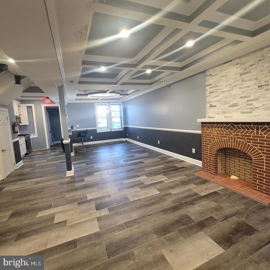 405 Lyndhurst Street Baltimore, MD 21229 - Photo 2 of 10 a view of an empty room with wooden floor