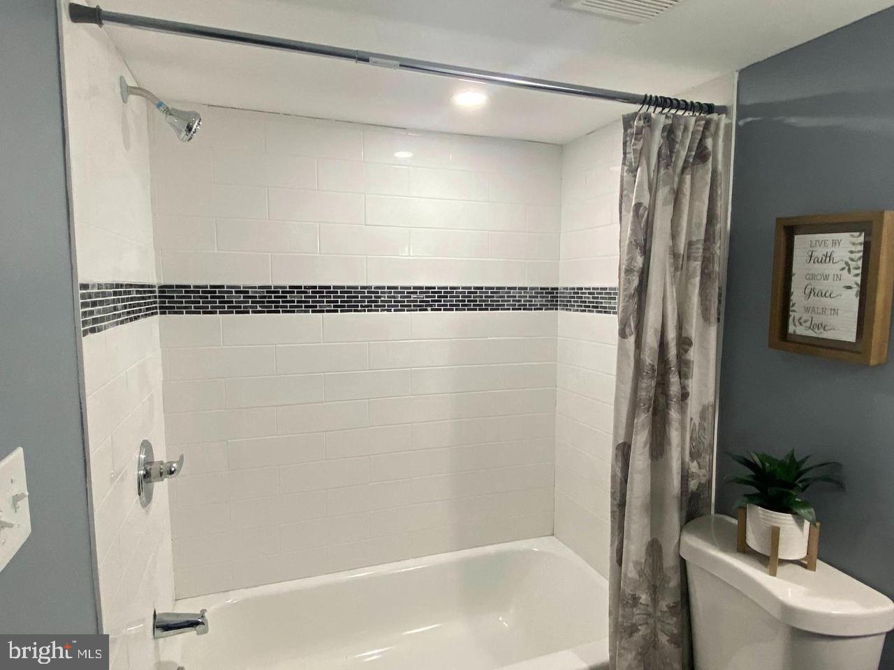 405 Lyndhurst Street Baltimore, MD 21229 - Photo 8 of 10 a bathroom with a shower a toilet and a shower