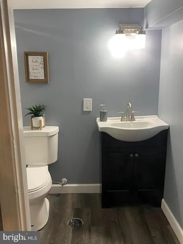 a bathroom with a toilet a sink and mirror