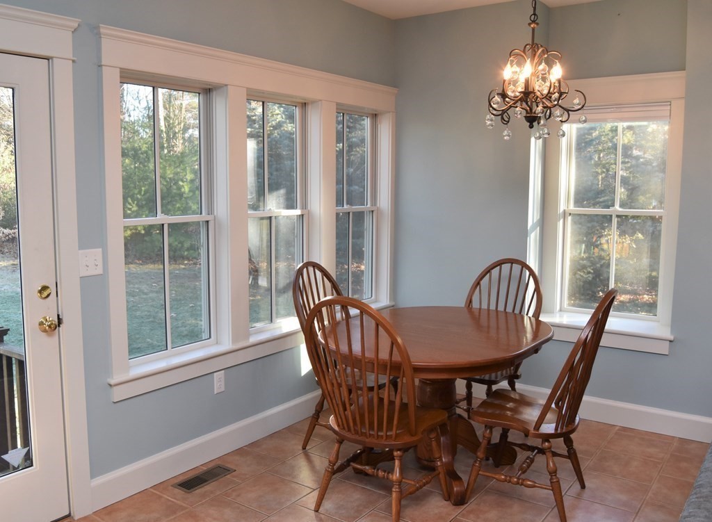 57 Linden Ridge Road Amherst, MA 01002 - Photo 8 of 42 a view of a dining room with furniture a chandelier and wooden floor
