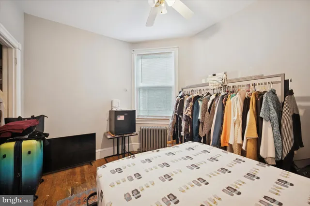 a view of a bedroom with wooden floor
