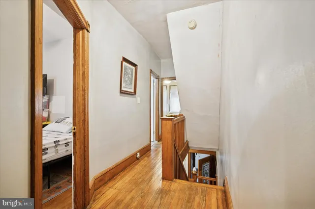 a view of hallway with wooden floor