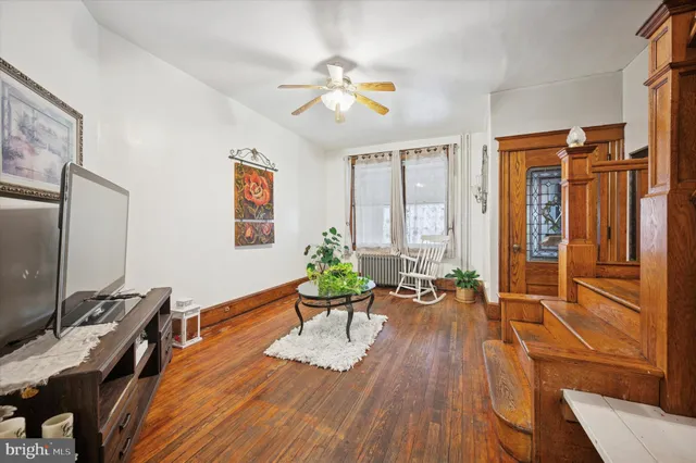 a view of a workspace with furniture window and wooden floor