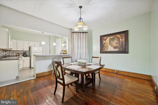 a view of a a dining room with furniture window and wooden floor