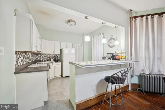 a kitchen with appliances cabinets and a table