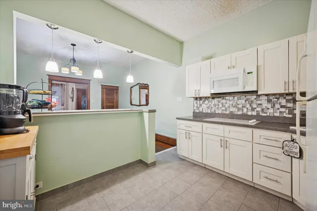 a kitchen with cabinets a sink and appliances