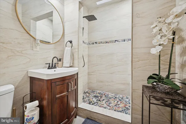 a bathroom with a sink a mirror and a shower