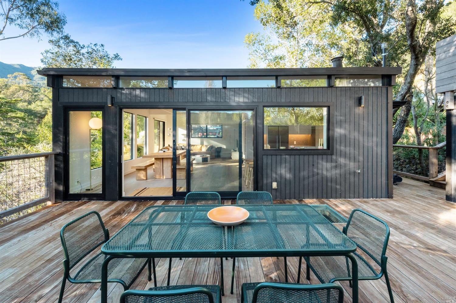 a backyard of a house with table and chairs