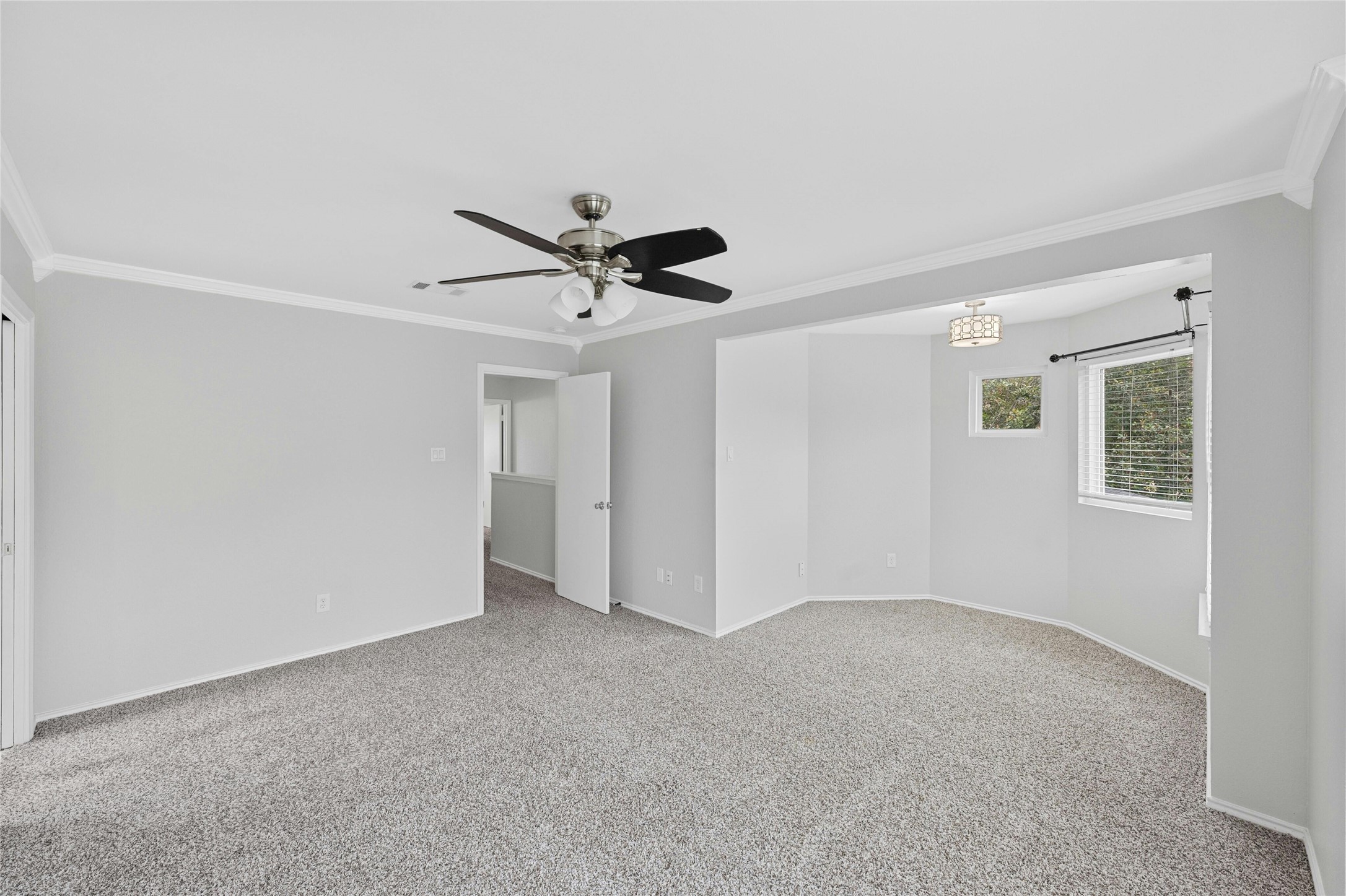 8303 Los Ranchos Drive Austin, TX 78749 - Photo 14 of 26 Empty room with ornamental molding, light colored carpet, and ceiling fan