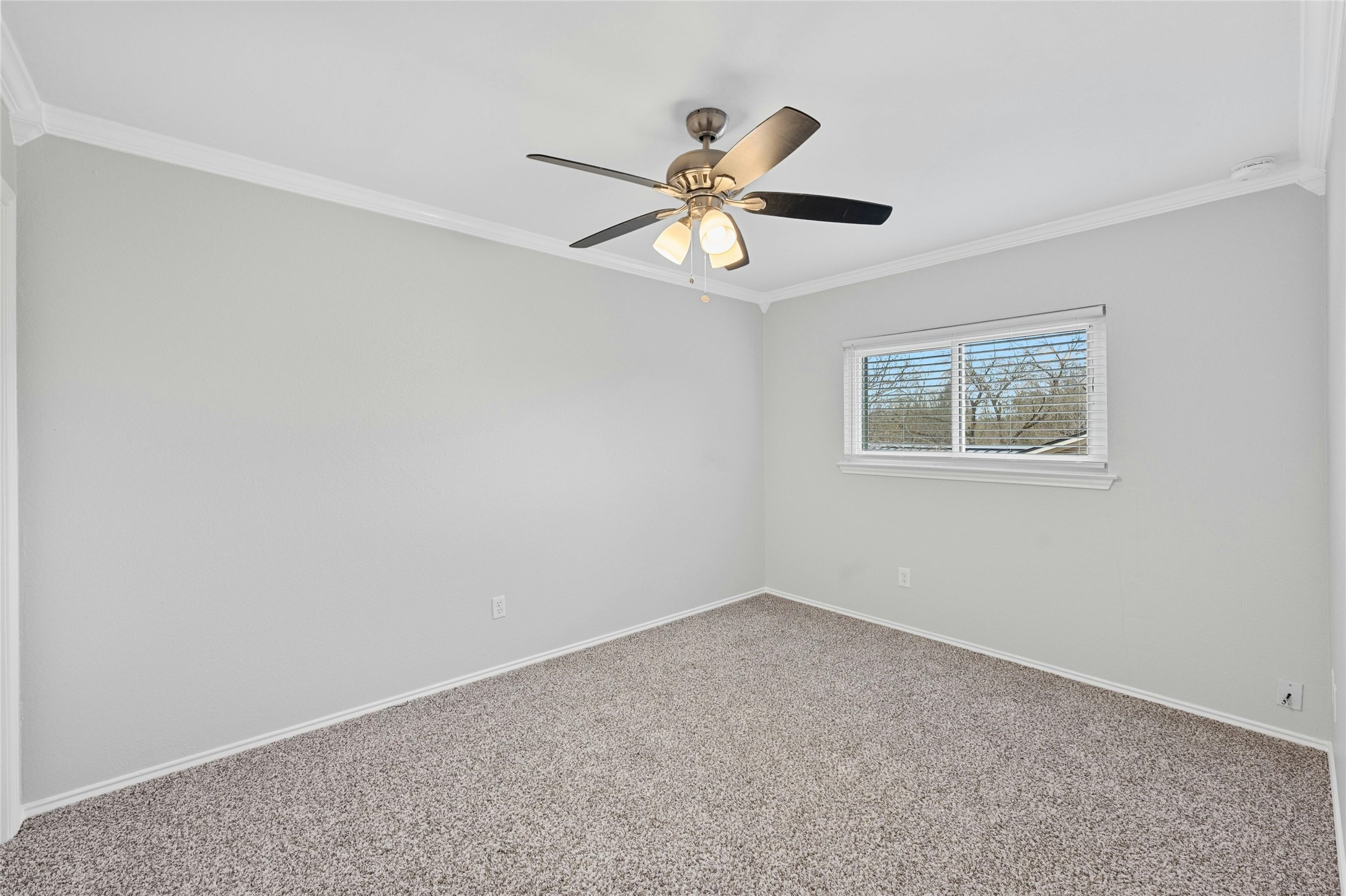 8303 Los Ranchos Drive Austin, TX 78749 - Photo 18 of 26 Carpeted empty room with crown molding and a ceiling fan