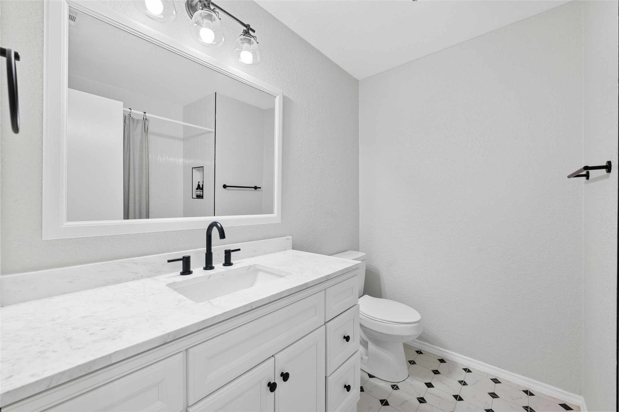 8303 Los Ranchos Drive Austin, TX 78749 - Photo 19 of 26 Bathroom with a shower with shower curtain, vanity, and light floors
