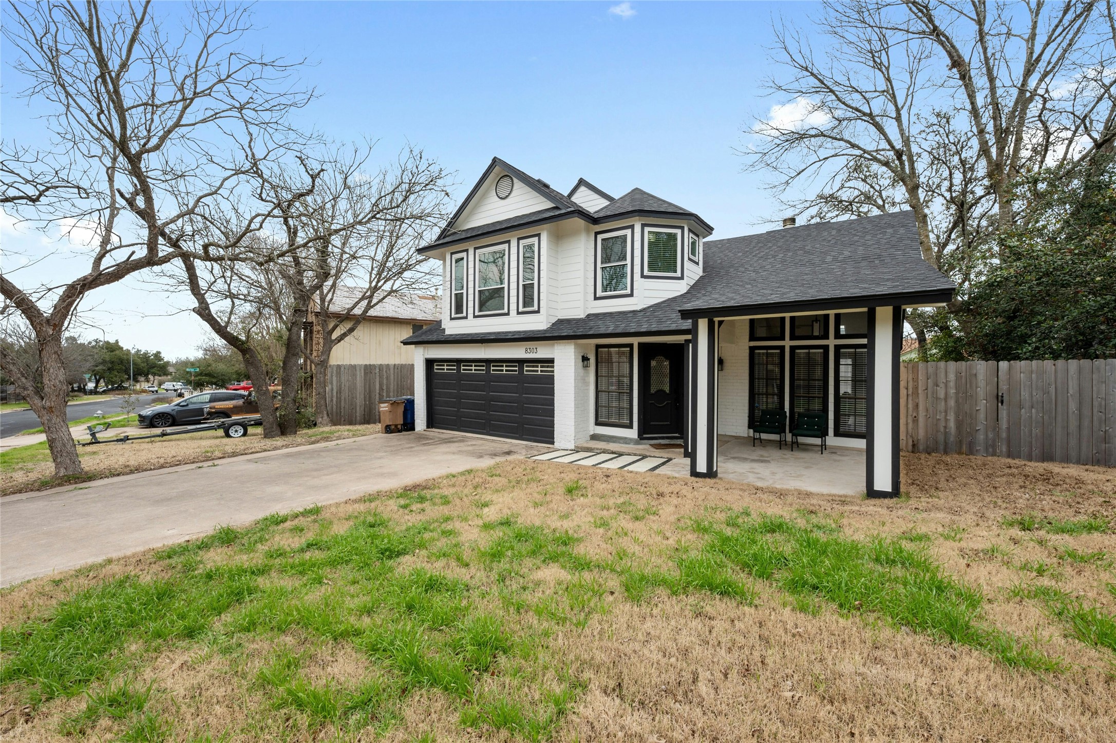 8303 Los Ranchos Drive Austin, TX 78749 - Photo 2 of 26 View of front of home featuring a shingled roof, concrete driveway, and an attached garage