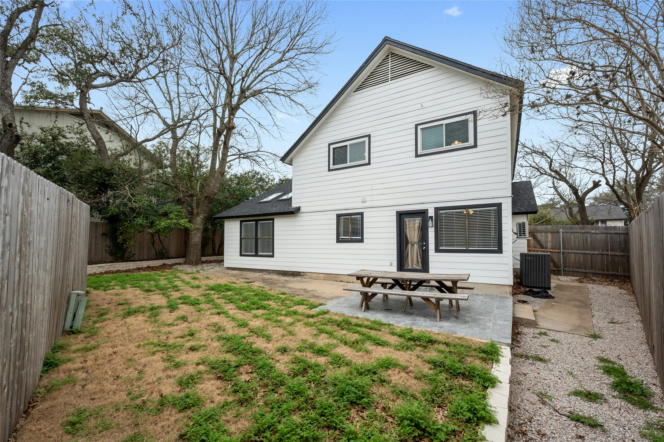 8303 Los Ranchos Drive Austin, TX 78749 - Photo 23 of 26 Rear view of house featuring a fenced backyard, a patio, and roof with shingles