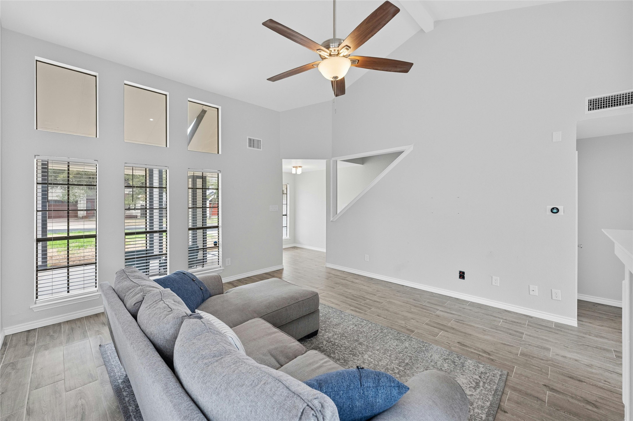 8303 Los Ranchos Drive Austin, TX 78749 - Photo 7 of 26 Living room featuring vaulted ceiling, light wood-type flooring, and a ceiling fan