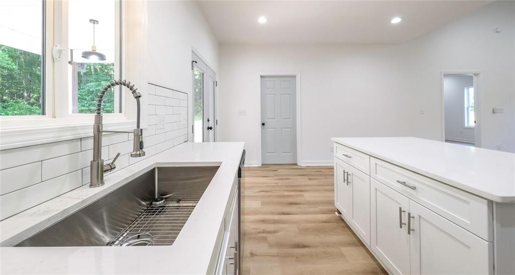 128 Pollard Road Temple, GA 30179 - Photo 14 of 36 a kitchen with a sink and a stove top oven