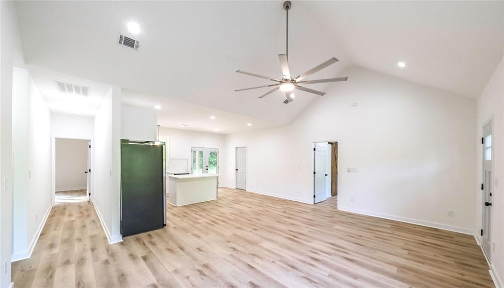 128 Pollard Road Temple, GA 30179 - Photo 16 of 36 a view of a kitchen with a refrigerator and a ceiling fan