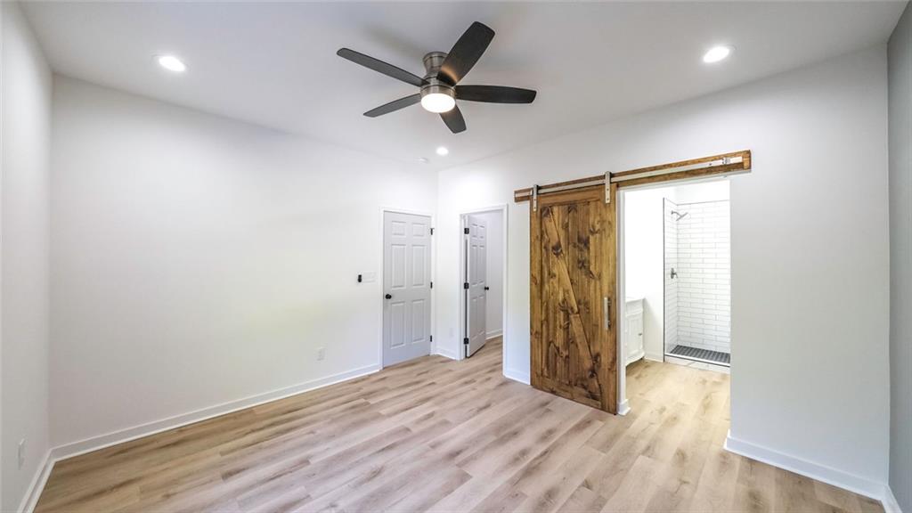 128 Pollard Road Temple, GA 30179 - Photo 18 of 36 a view of an empty room with wooden floor and a window
