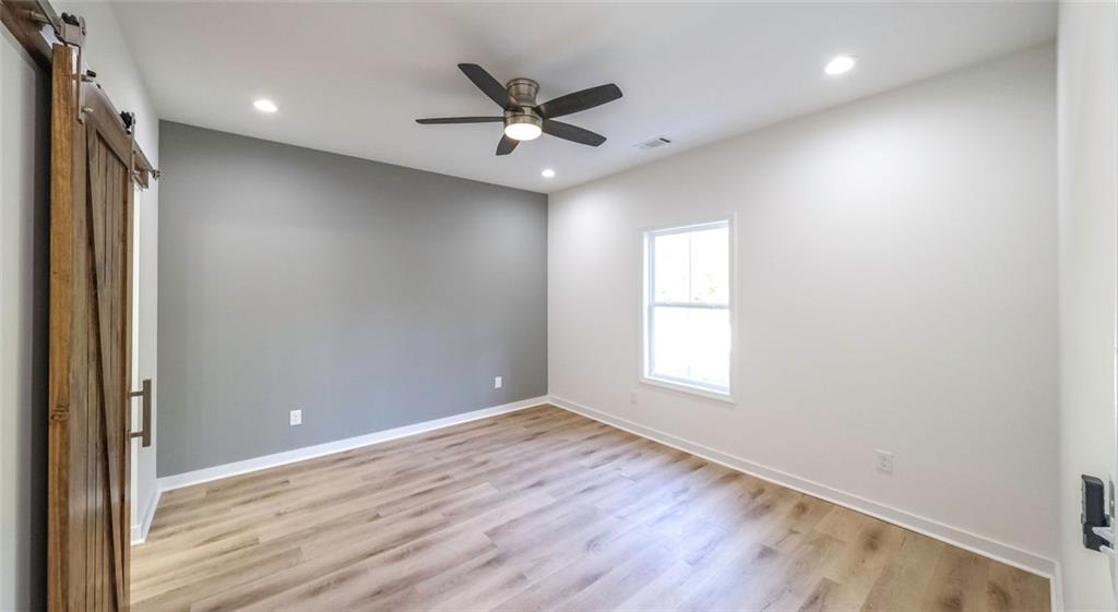 128 Pollard Road Temple, GA 30179 - Photo 20 of 36 an empty room with wooden floor and windows