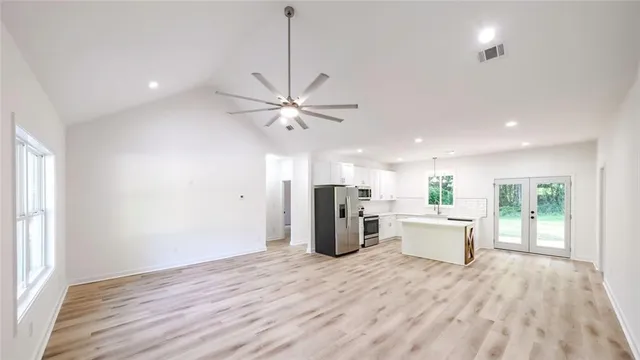 a view of a kitchen with a sink dishwasher and wooden floor