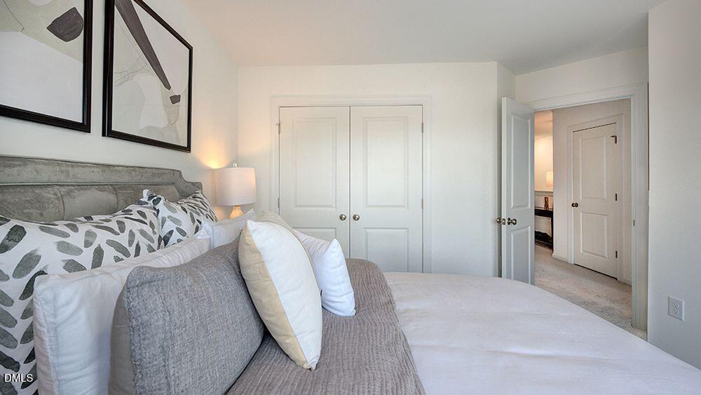 216 Hank Way Willow Spring, NC 27592 - Photo 13 of 42 a bedroom with a bed and a mirror