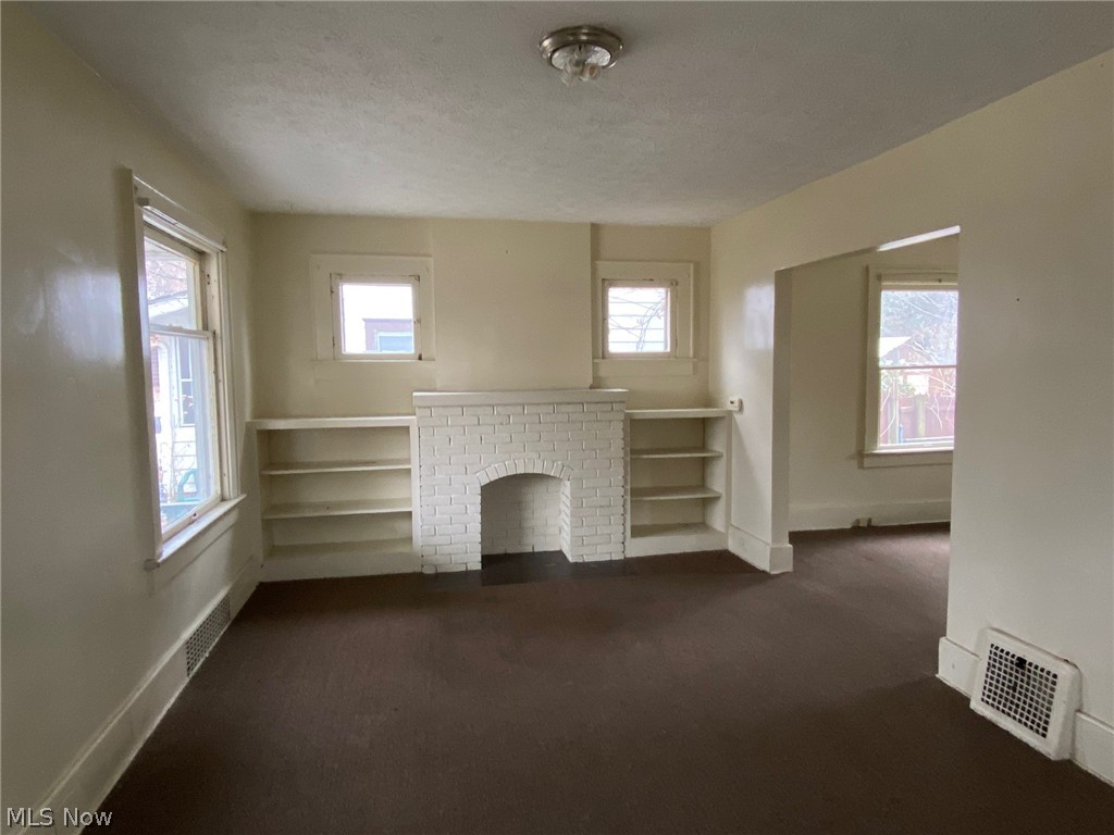 291 Lookout Avenue Akron, OH 44310 - Photo 6 of 23 living room with fireplace and bookshelves