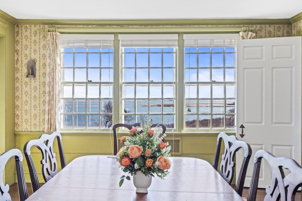 504 Old Harbor Road Chatham, MA 02633 - Photo 13 of 42 a living room with furniture and floor to ceiling windows