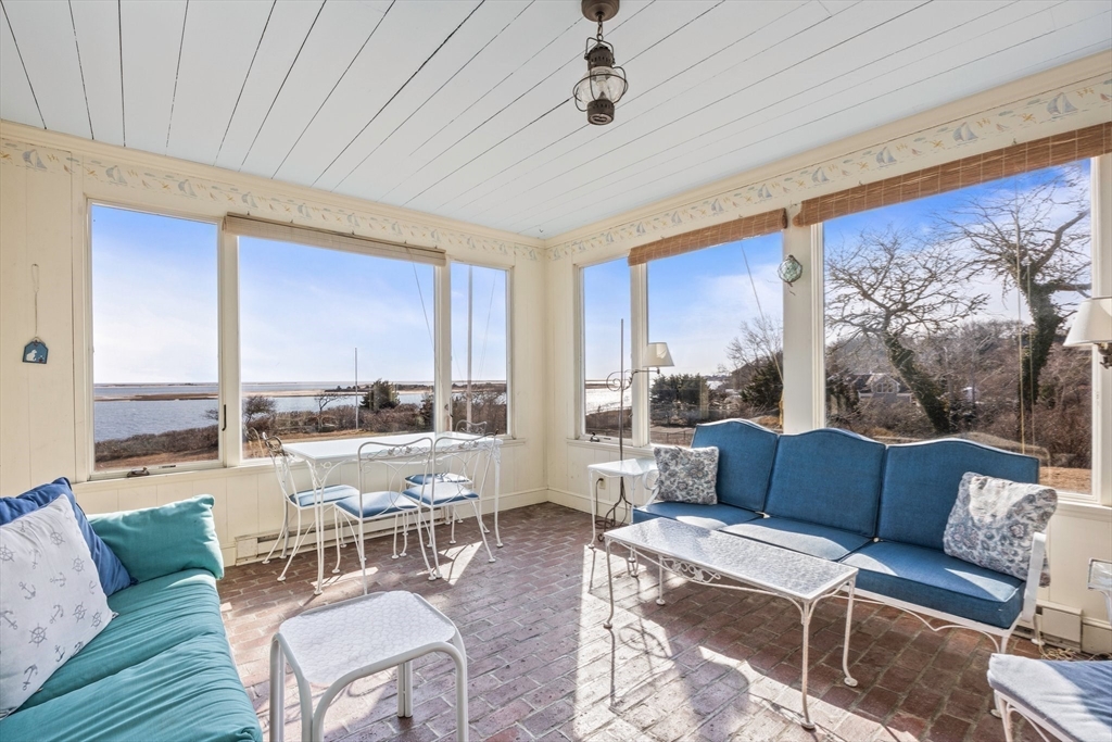 504 Old Harbor Road Chatham, MA 02633 - Photo 15 of 42 a living room with furniture and a large window